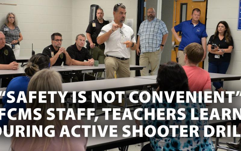 Fannin County Sheriff Dane Kirby, seated, right, and school resource officers and deputy sheriffs  Anthony Walden, seated, and Jim Burrell, listen as Fannin County School System Associate Superintendent Darren Danner talks to Fannin County Middle School staff following the active shooter drill at the school. Kirby told the staff that, while there is no way to be prepared for every situation, “you’re training will kick in.”
