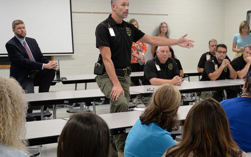 School Resource Officer Commander and Fannin County Deputy Sheriff Lieutenant Darvin Couch talks about the importance of training with Fannin County Middle School staff members last week. Couch spoke following an active shooter drill. In back at left is Superintendent of Schools Dr. Michael Gwatney who took part in the drill.