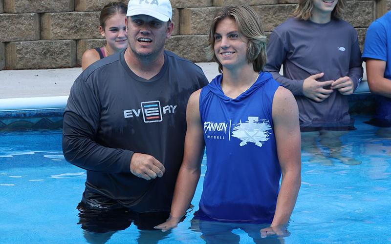 Lawson Sullivan, right, shows his excitement by smiling wide as Matt Queen, left, explains the profession of faith by baptism.