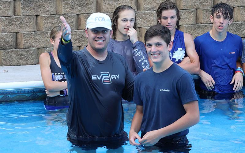 Matt Queen, left, North Central Georgia director for the Fellowship of Christian Athletes, explains the act of baptism before baptizing a smiling Vince Foster Tuesday, September 6.
