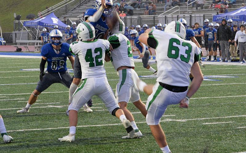 Braden Taylor (10) jumps fully extended in an effort to block a punt by Pickens County while Nate Maloof (63) stays in coverage.