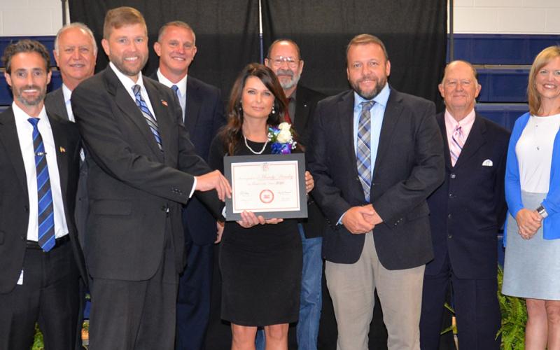 Fannin County High School’s Mandy Housley received special congratulations after being named Teacher of the year. She is shown with from left, front, Lucas Roof, Dr. Michael Gwatney, Housley, Dr. Scott Ramsey, Bobby Bearden, Shannon Miller, and, back, Terry Bramlett, Chad Galloway and Lewis DeWeese.