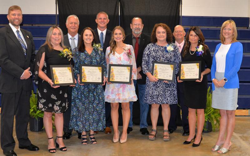 Fannin County Teachers of the Year for their respective schools are shown with school board members and school officials. From left, front are School Superintendent Dr. Michael Gwatney, Stacy Herndon, Tiffany Brown, Alex Whitener, Amanda Thomas, Mandy Housley, and incoming School Superintendent Shannon Miller, and, back, school board members Terry Bramlett, Chad Galloway, Lewis DeWeese and Bobby Bearden.