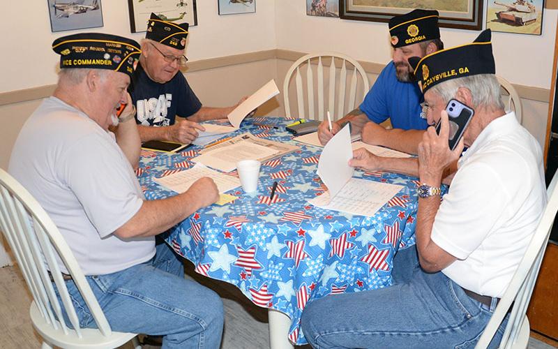 Jim Cantrell, Chris McKee, Howard “Catfish” Adkins and Ronnie Rabun, from left, call fellow members of American Legion Post #248 as part of the Legion’s Buddy System. The team gathered at the Veterans Conference Center in Blue Ridge last week to complete the mission.