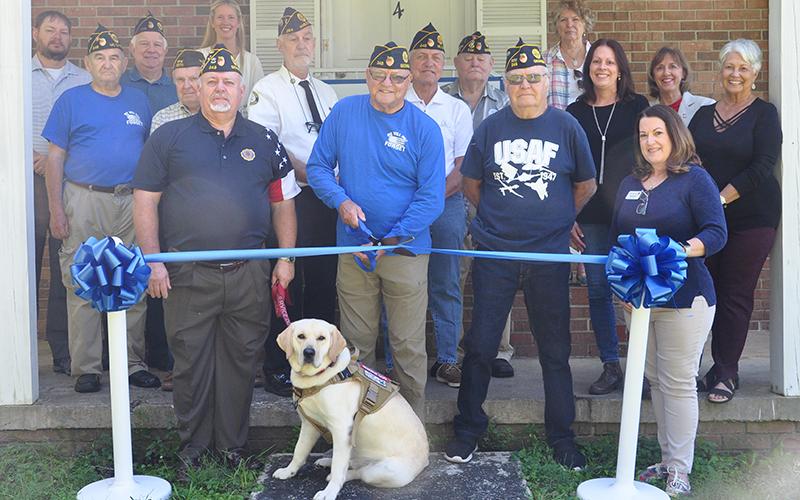 News Observer photo/Hannah Jack Shown cutting the ribbon is Commander Richard Crosley. Attending the ribbon cutting with him were Shane Baugh, John Grizzell, Ron Wallace, Larry Dyer, James Callender and his servic dog Louie, Steve Strickland, Ronnie Rabun, Gerald “Chief Mac” McMillen, Chris McKee, Amy Curtis, Pam Fink, Deborah Calloway, Leslie Callendar, Dianne Mallernee and Glenda Reilly.