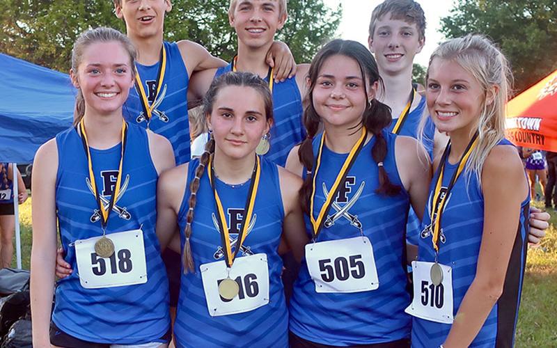 Medalists from the Rockmart Invitational smile after thier race. Shown are, from left front, Olivia Temples, Karli Sams, Kristin Cipich and Lindsey Holloway; and back, Benjamin Bloch, Gavin Davis and Luke Callihan.