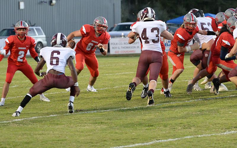 Addison Hook (61) runs the ball as Isaac Deal (7) clears a path with a block in recent action for the Copper Basin Cougars football team.