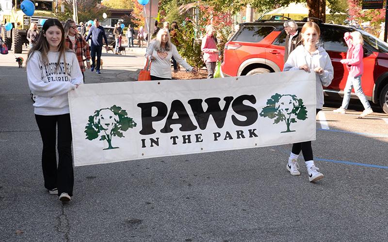 The Paws in the Park parade drew a huge crowd of owners and their pets to downtown Blue Ridge Saturday morning. These young ladies introduced the start of the event behind Fannin County Fire Chief Larry Thomas who led the parade with his truck blaring, “Who Let the Dogs Out.”