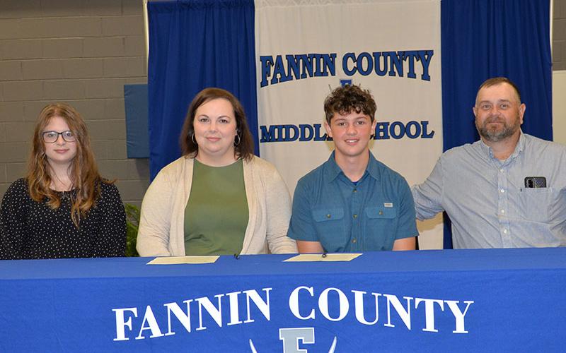 REACH scholar Elijah (Eli) Queen signed his contract last week with his parents, Victoria Queen and Darren Queen. Also shown during the signing ceremony is Madison Queen, left.