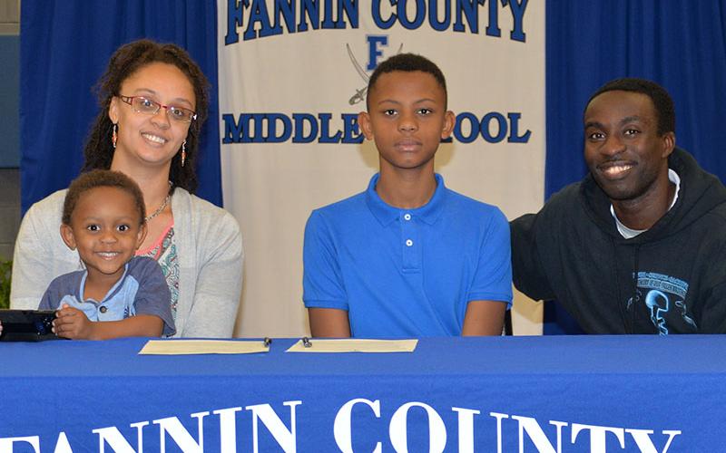 Jamari Patterson is one of five REACH scholars chosen this year at Fannin County Middle School. After signing his contract, he is shown with his mother, Silhouette Jarmon-Gigetts, his step-father, Lawrence Jarmon-Gigettis and Gabriel Jarmon-Gigetts.