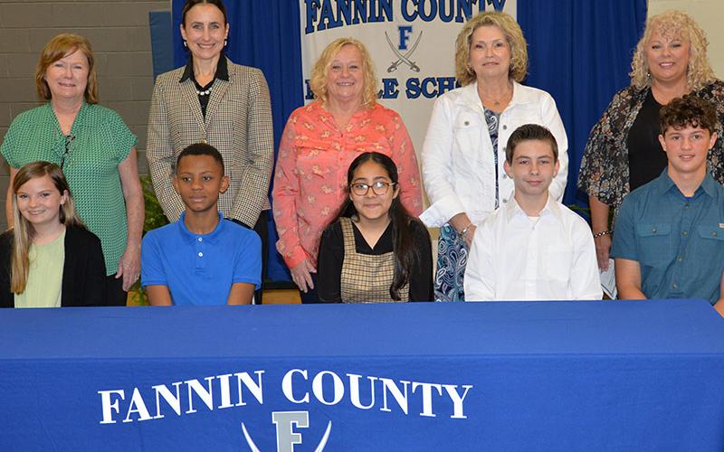 This year’s class of REACH scholars and their mentors are shown at the conclusion of last week’s signing ceremony. Shown, from left, are Sarah Brawley, Jamari Patterson, Lesly Alvarado, Ronald Kendall, and Elijah Queen, and, back, FCMS Counselor Shandra English filling in for Sheree Ralston, Summer Leifer, Rhonda Daves, Melissa King and Cindy Hicks.