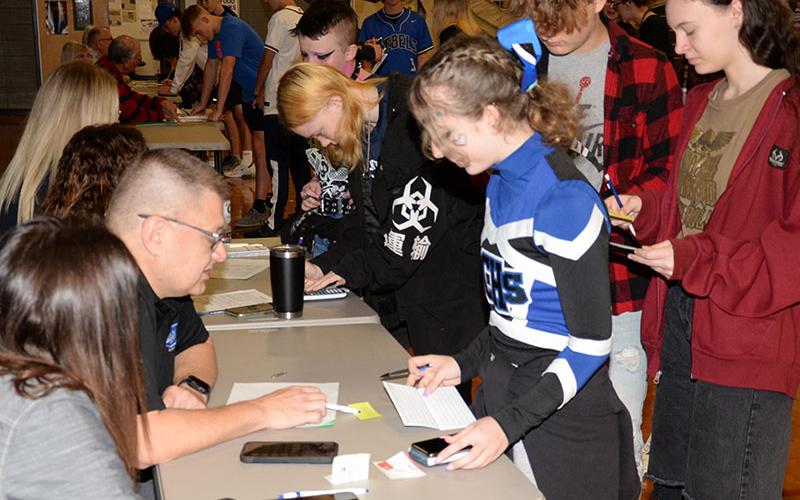 Lexi Cook gets advice from Daniel Walker of Kevin Panter Insurance during Reality Day at Fannin County High School.