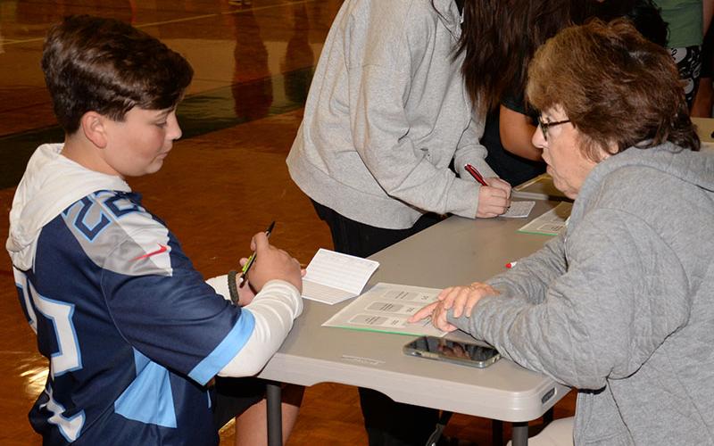 Chris Martinez explains the specifics of some financial planning to Fannin County High School ninth grader Garvin Barnett during Reality Day. The event was hosted by the school with help from Fannin County Family Connection and area businesses.