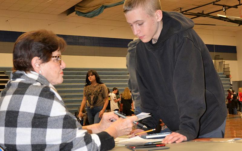 Hope Burns helps Hunter Byrd with his financial planning during Reality Day.