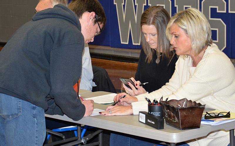 Stacy Lewis of Mountain Valley Community Bank, right, and Kelly Henson of Lendmark Financial Services explain financial planning to one of the Fannin County High School ninth graders who took park in Reality Day.