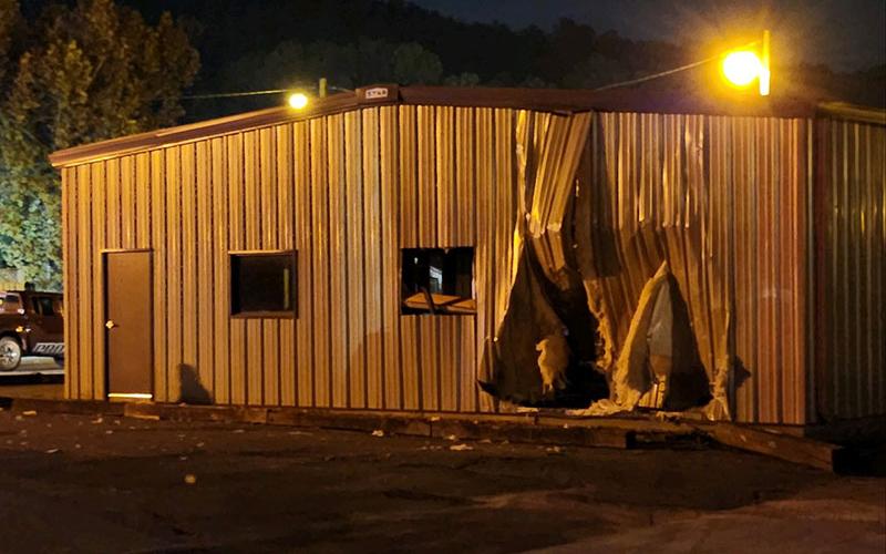 The hole in the building at the end of Ferry Street (above) indicates where the Ford SUV in the top photo first crashed into the Copperhill building. The driver of the SUV reported fled on foot after the crash.