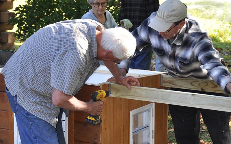 Pictured are Tim Pauley, left, and Phil Peet. Safe Pet Project provided the funds for Pauley to lead the doghouse building project.