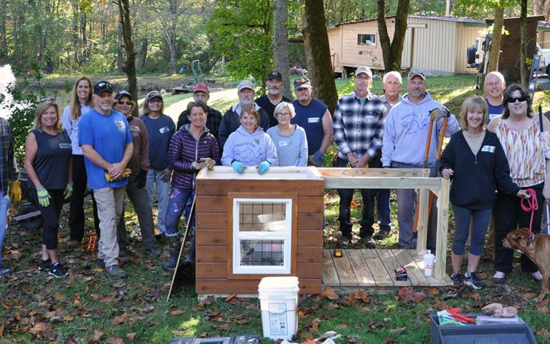 Several volunteers from Freedom for Fido, Barking Buddies, Safe Pet Project, Animal Control, and community members came out to Archie’s new home to build him a fence and a dog house. Pictured, from left, are Scott Reid, Priscilla Reid, Jen Tindle, Paul Aigner, Meri Aigner, Dana Worm, Carol Shannon, Ken Williams, Jim Williams, Jackie Gilbert, Russ Peiffer, Betty Williams, Steve Turek, Phil Peet, Tim Pauley, Jim Tindle, Donna Turek, Debi Holcomb, Archie, and David Johns.