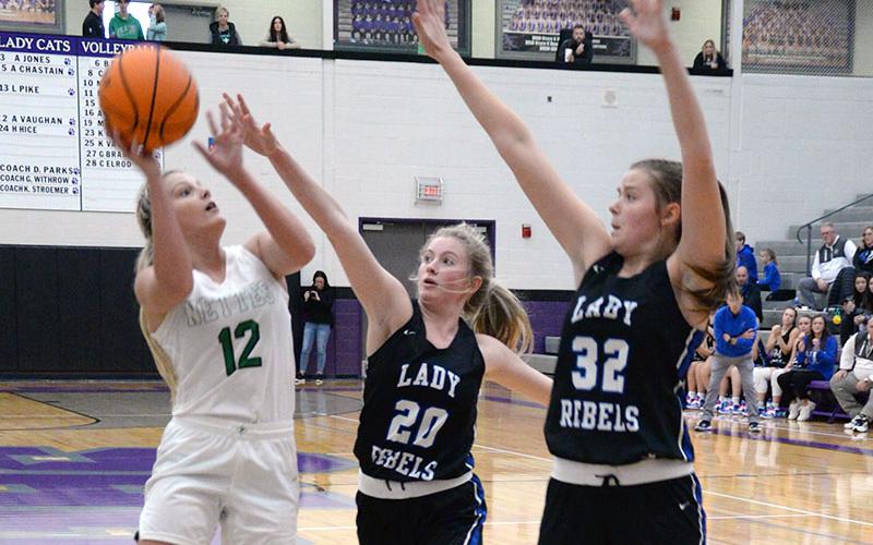 Ava Queen (20) and Macy Hawkins (32) attempt to block a shot by Pickens County’s Beth Hopkins in the first round of the ETC tournament in Ellijay. For more from the contest, please see B3.