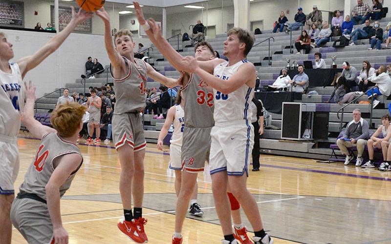 The Rebels and the Cougars all fight for a rebound in last Tuesday’s ETC Tipoff Tournament matchup. For the Cougars, from left, Kelle Shroth, Talon Smith and Reece Parris go for the ball, and for the Rebels, Lucus Hanson, left, and Gavin Mowery, right, fight to get a hand on it.