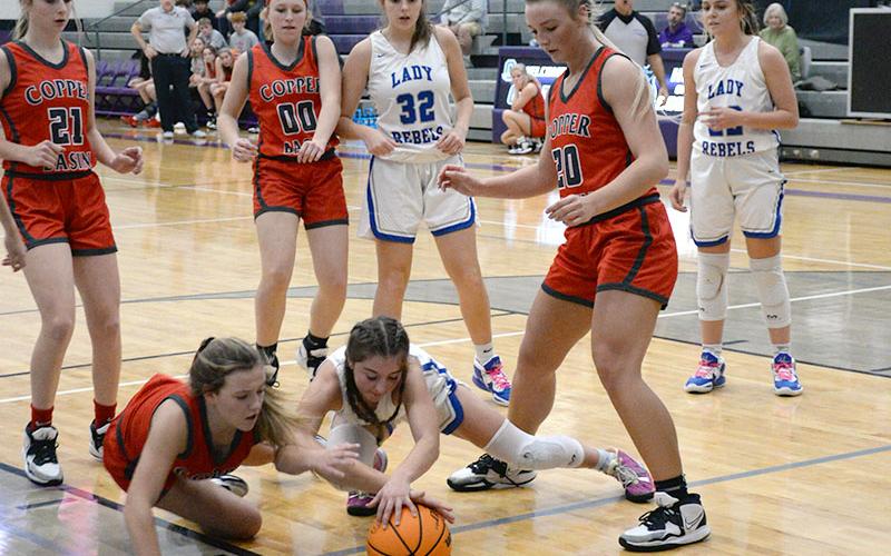 Kendra Deal of the Lady Cougars and Courtney Davis of the Lady Rebels dive on the ground for a loose ball while Alexis Hyatt (Basin, 21), Cora Kimsey (Basin, 00), Macy Hawkins (Fannin, 32) and Sapporiah Ross (Basin, 20) all wait to see who comes up with it.