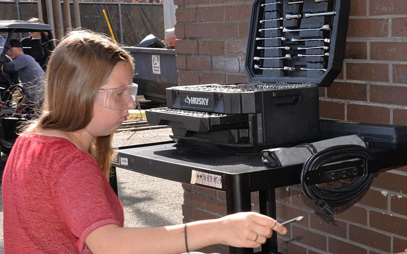 Casi Mealer gets the correct wrench for a project in the Autmotive Technology program at FCHS.