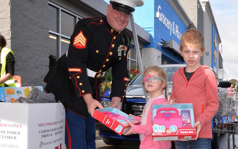 Eleanor and Theodore Parsons-Cohrs dropped off donations at Toys for Tots’ Stuff the Truck at the Blue Ridge Walmart parking lot Saturday morning. Accepting the donations is Marine Corps Sergeant Brent Ware. Toys for Tots is still taking requests for help at the Fannin County Family Connection building through December 14 and collecting toys through the same day. Distribution will be at Family Connection Friday and Saturday, December 16 and 17, from 10 a.m. until 6 p.m. each day.