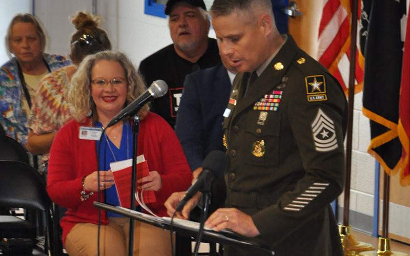 East Fannin Elementary Assistant Principal Andrea Cook is all smiles during special guest Sargeant Major Russell Blackwell’s speech for the school’s Veteran’s Day Program.