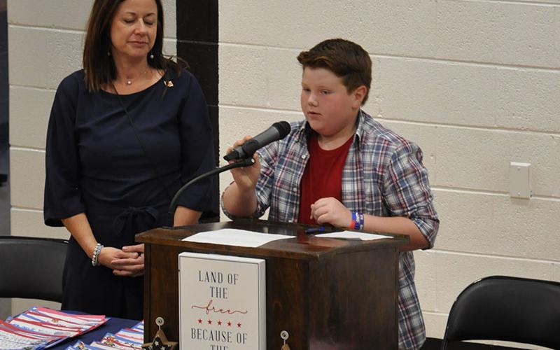 Pictured are West Fannin Elementary School student Jonah Strobel and Principal Alison Danner. Strobel is shown leading his fellow students in the Pledge of Allegiance during their Veteran’s Day Program November 9.