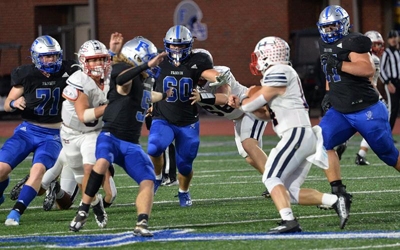 Jeremy Tammen (71), Cooper Hilliard (5), Jacob Dye (60) and Logan Long (77) sets their sights on the ball carrier in recent action for the Rebels. They will travel to Callaway to face the Cavaliers Friday, November 18.