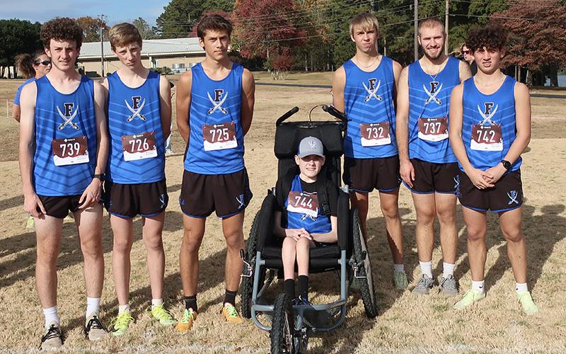 The FCHS Rebels cross country team smiles after placing second in the Region Meet Tuesday, October 25. Shown are, from left, Conner Kyle, Luke Callihan, Benjamin Bloch, Brady Smith, Gavin Davis, Sam Jabaley and Zechariah Prater.