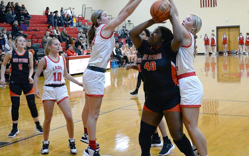 Zoe Green, left, and Sapporiah Ross, right, get big for Copper Basin to to block a shot attempt against the South Pittsburg Lady Pirates.