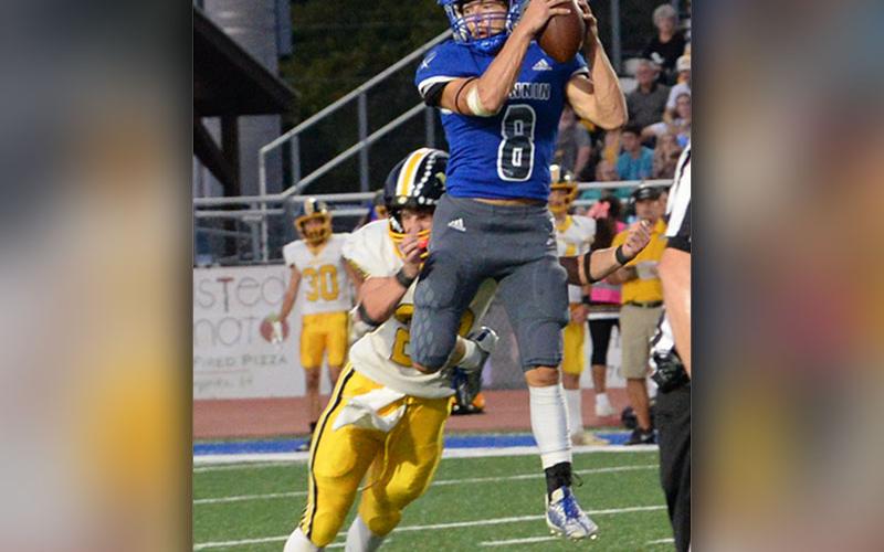 The Region 7AA’s Athlete of the Year, Corbin Davenport, goes high in the air to catch a pass in action for the Fannin County Rebels this season.