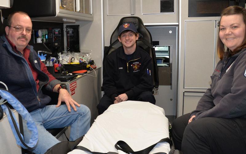 Trent Lowery, center, is taking advantage of a partnership between the Fannin County Emergency Management Agency/Emergency Medical Services and the Fannin County School System that will qualify him for a career before he graduates from high school. With Lowery are EMT instructor Bill Brown and EMS Director Becky Huffman.