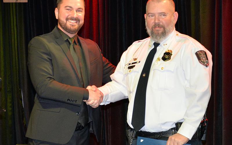 Cory Collogan, right, McCaysville’s new assistant police chief, is congratulated by Chief of Police Michael Earley.