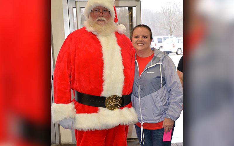 Shop With a Cop board member Dawn Cochran welcomed Santa Claus to Walmart Saturday to help children make their Christmas decisions.