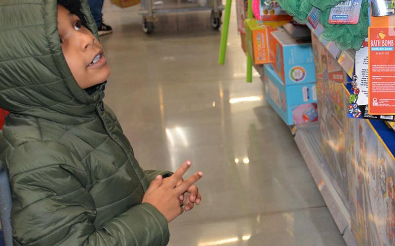 Picking out the perfect Christmas toy proved to be a challenge for this Shop With a Cop youngster.
