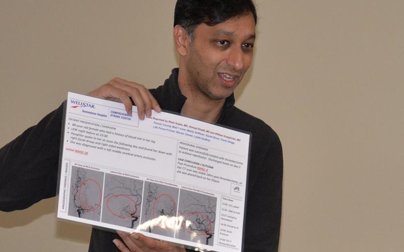 Dr. Rishi Gupta displays the poster created for Kennestone Hospital’s Comprehensive Stroke Center after a partnership involving a Fannin County EMS crew, Life Force, and Kennestone Hospital resulted in an 88-year-old stroke patient’s miraculous recovery.