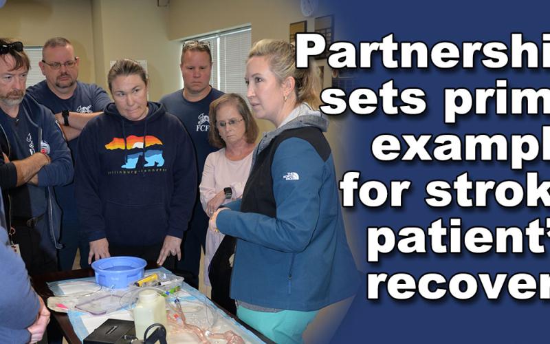 Elizabeth Lynch, right, demonstrates the new technology at Kennestone Hospital that helped heal a Fannin County stroke patient. Fannin County Emergency Medical Service employees watching the demonstration are, from left, Michael Schuhle, Eric Sowers, Brian Herndon, Carolyn McLinden, Clinton Hughes, and Becky Callihan.