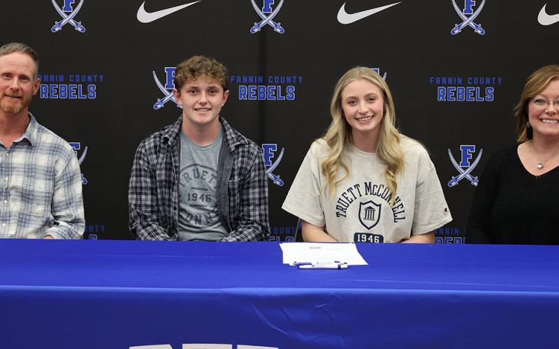 Ava Queen and her family smile after she signed her letter of intent to attend and play basketball at Truett McConnell University. Shown are, from left, Jeff Queen, Eli Queen, Ava Queen and Tara Queen.