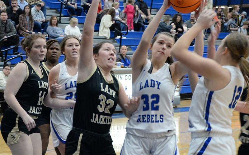 Macy Hawkins (32) fights for a rebound while Addison Smith (25) and Callie Ensley (12) look to help in Friday’s night region win over Rockmart.
