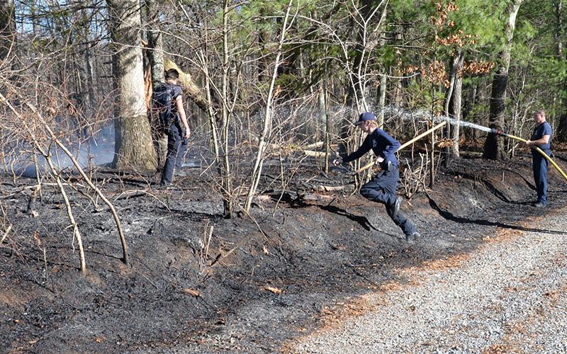 Fannin County firefighters quickly extinguished this brush fire off Henson Way in the Sugar Creek area Thursday afternoon. Among the firefighters responding to the call were, from left, Channing Johnstone, Trent Lowery, and Clinton Hughes.