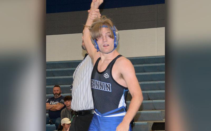 Senior Taylor Collis raises his hand in victory.