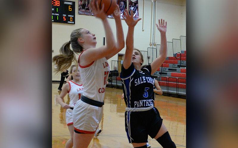 Lady Cougar Alexis Hyatt (#21) elevates for a contested two in recent Copper Basin basketball action.