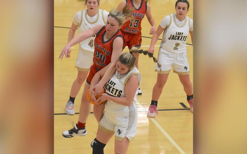 Lady Cougar Cora Kimsey (00) battles for a rebound and Kendra Deal (13) waits for the outcome in recent Copper Basin basketball action.