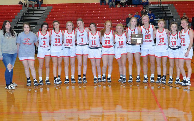The Lady Cougars basketball team smiled together after being awarded the District Runner-Up plaque after the game Friday, February 17. Shown are, from left, Alyvia Harris, Lexy Jory, Brilee Harris, Sarah Collis, Cora Kimsey, Peyton Grabowski, Riley Akens, Peyton Williamson, Destiny Pittman, Alexis Hyatt, Sapporiah Ross, Riley Hall, Kendra Deal and Zoe Green.