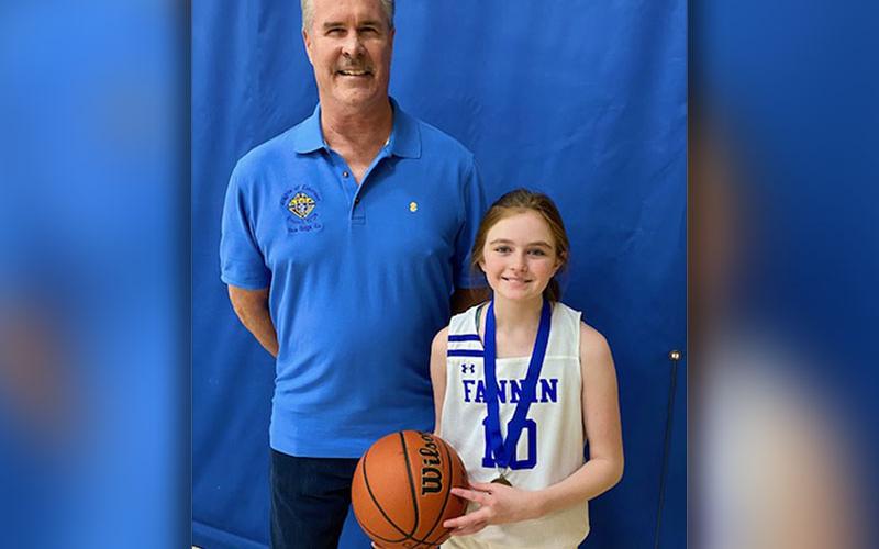 Addison Head won the 12 year old girls free throw competition. She is shown with Jack Devine of the Knights of Columbus, sponsors of the event.