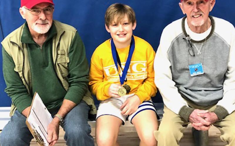 The 12 year old boys free throw winner, Garrison Ensley, is shown with Don Wirtz, left, and Bob Soph.