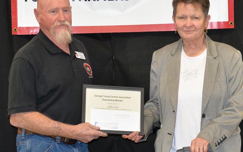 Fannin County Young Farmers Association President Kenny Queen presented Gilda Lyons the organization’s Outstanding Member award.