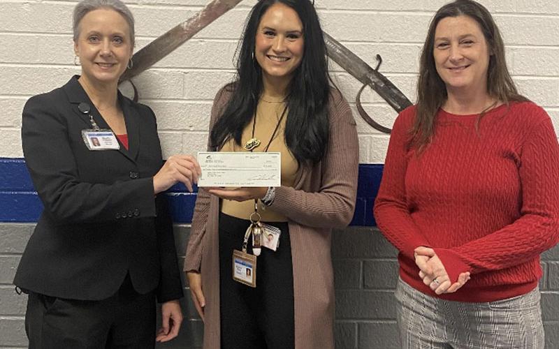 Martha Williams, from left, presented a Farm to School grant check to Kristen Stone and Amy Adams at Fannin County High School.